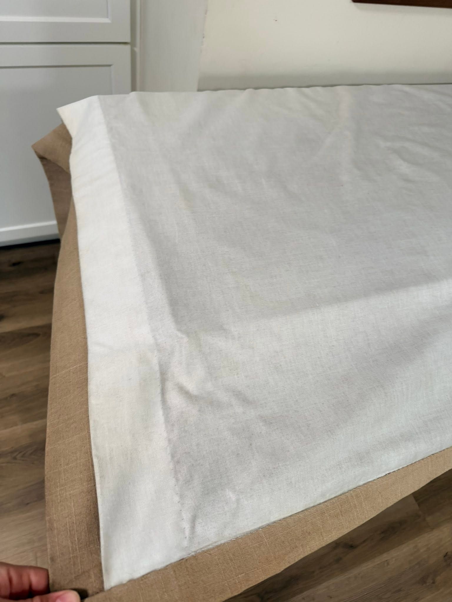 A clean white drape with a tan border, laid flat